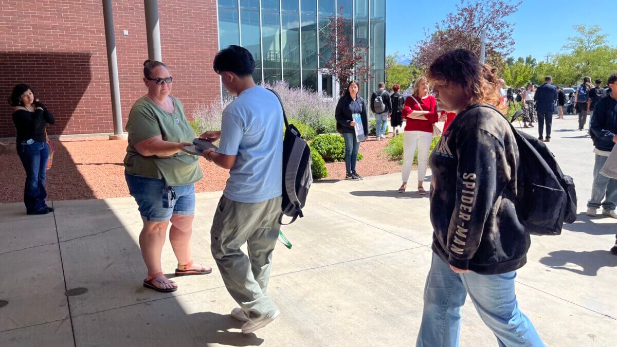 Granger High School students unlock magnetic locking pouches containing their phones after class with a newly-established a phone-free policy on Aug. 26, 2024. (Alixel Cabrera/Utah News Dispatch)