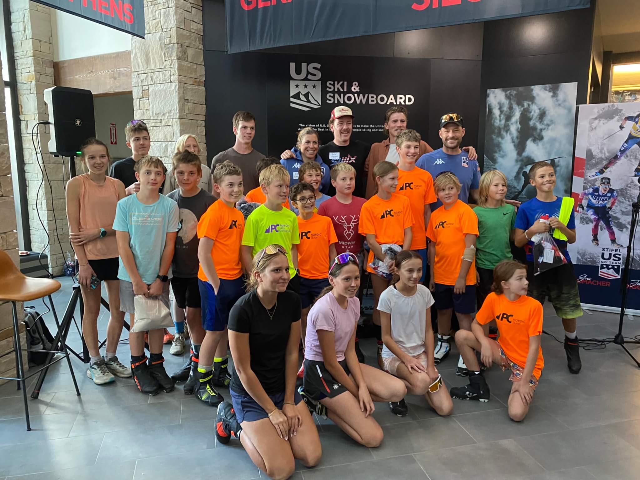 Ben Ogden (center, back row, white cap) alongside Rosie Brennan (to his left) with the Park City Ski & Snowboard Cross Country Team in Park City at the U.S. Ski Team Headquarters.