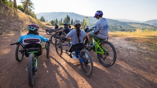 Adaptive mountain bikers out on the trail.