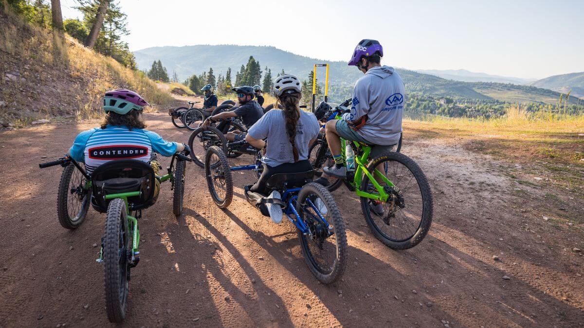Adaptive mountain bikers out on the trail.