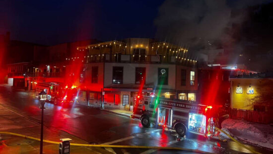 Park City Fire District trucks line Main Street Thursday night as smoke rises from the roof of Chimayo restaurant.