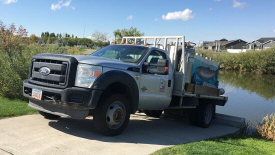 DWR fish hatchery vehicle stocks a Utah pond.