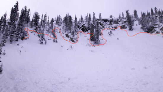 Photo of the terrain where the slide occurred. The victim entered from the left side of the photo, traversing into the bowl. he red line depicts the crown of the avalanche.