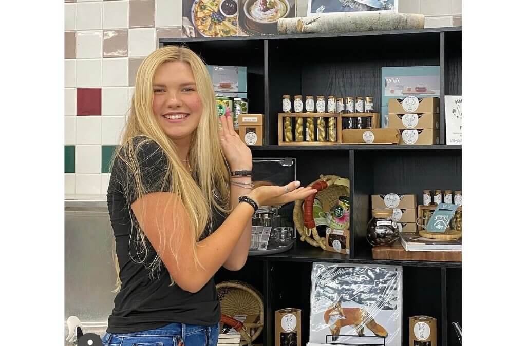 Lace poses with Park City PUPU products at a local retail display. The boutique organic candy line, which she co-founded at age 15, is inspired by the moose that wintered in her family's backyard for nearly two decades.