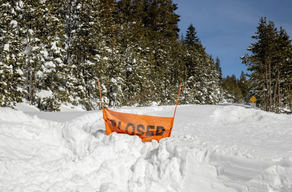 A closed sign is partially buried at the entrance to the Castle Peak trailhead in Soda Springs, Calif., Friday Feb. 20, 2026