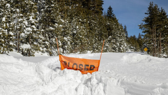 A closed sign is partially buried at the entrance to the Castle Peak trailhead in Soda Springs, Calif., Friday Feb. 20, 2026