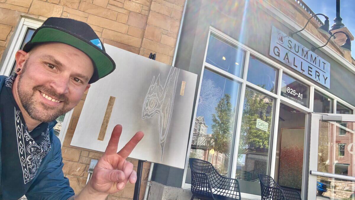 Cie Hoover stands outside Summit Gallery on Park City’s Main Street, where the Colorado-based artist’s wood-relief works are now on display.