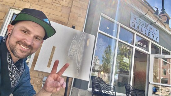 Cie Hoover stands outside Summit Gallery on Park City’s Main Street, where the Colorado-based artist’s wood-relief works are now on display.