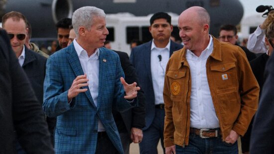 Gov. Spencer Cox, right, on the tarmac in front of a U.S. Air Force C-17 will host the Operation Gigawatt Summit Friday at the Grand Hyatt Deer Valley.
