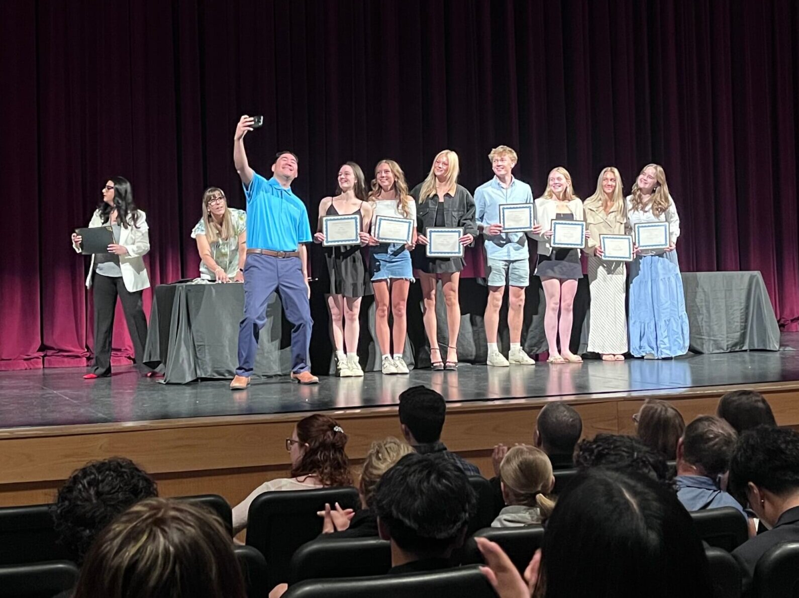 Doctor taking group selfie after awarding the following scholarships for the Intermountain Health Career Academy: (not in order) Anna Centurier-Harris, Anabelle Ellis, Annabelle Croney, Benjamin Gibbs, Caroline Keagy, Elizabeth Andersen-Lum, Finley Kelly, Kayla Fauvell, and Skye Rolley. 