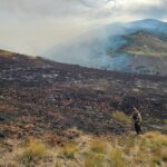 A fire crew member continues to target hotspots in the Rocky Canyon Fire burn area.
