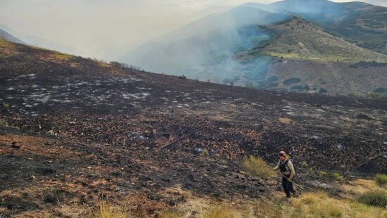 A fire crew member continues to target hotspots in the Rocky Canyon Fire burn area.