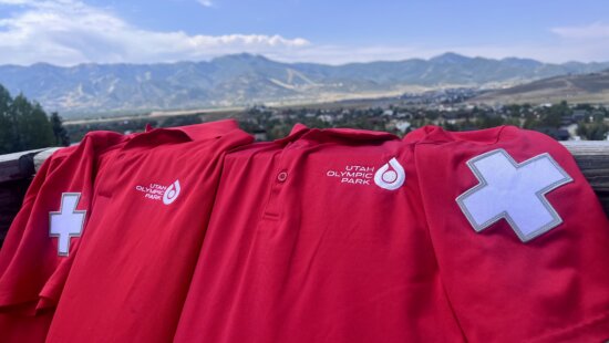 Utah Olympic Park in the background, Utah Olympic Park Ski Patrol uniforms front and center.