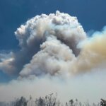 A massive smoke column rises from the Rocky Canyon Fire burning in the East Canyon area