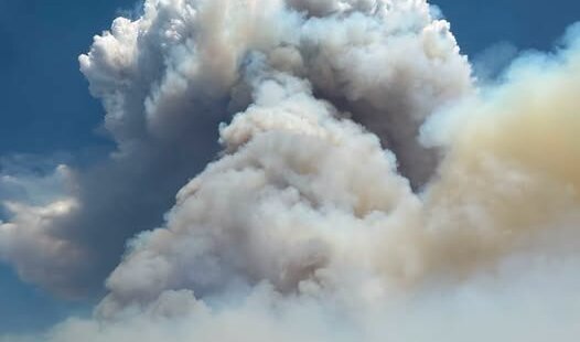 A massive smoke column rises from the Rocky Canyon Fire burning in the East Canyon area
