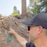 US Open co-founder Clay Harper points out Niagara, a rock section preserved from the original early-2000s NCS track. The classic feature now flows into a rebuilt exit with a larger, faster berm