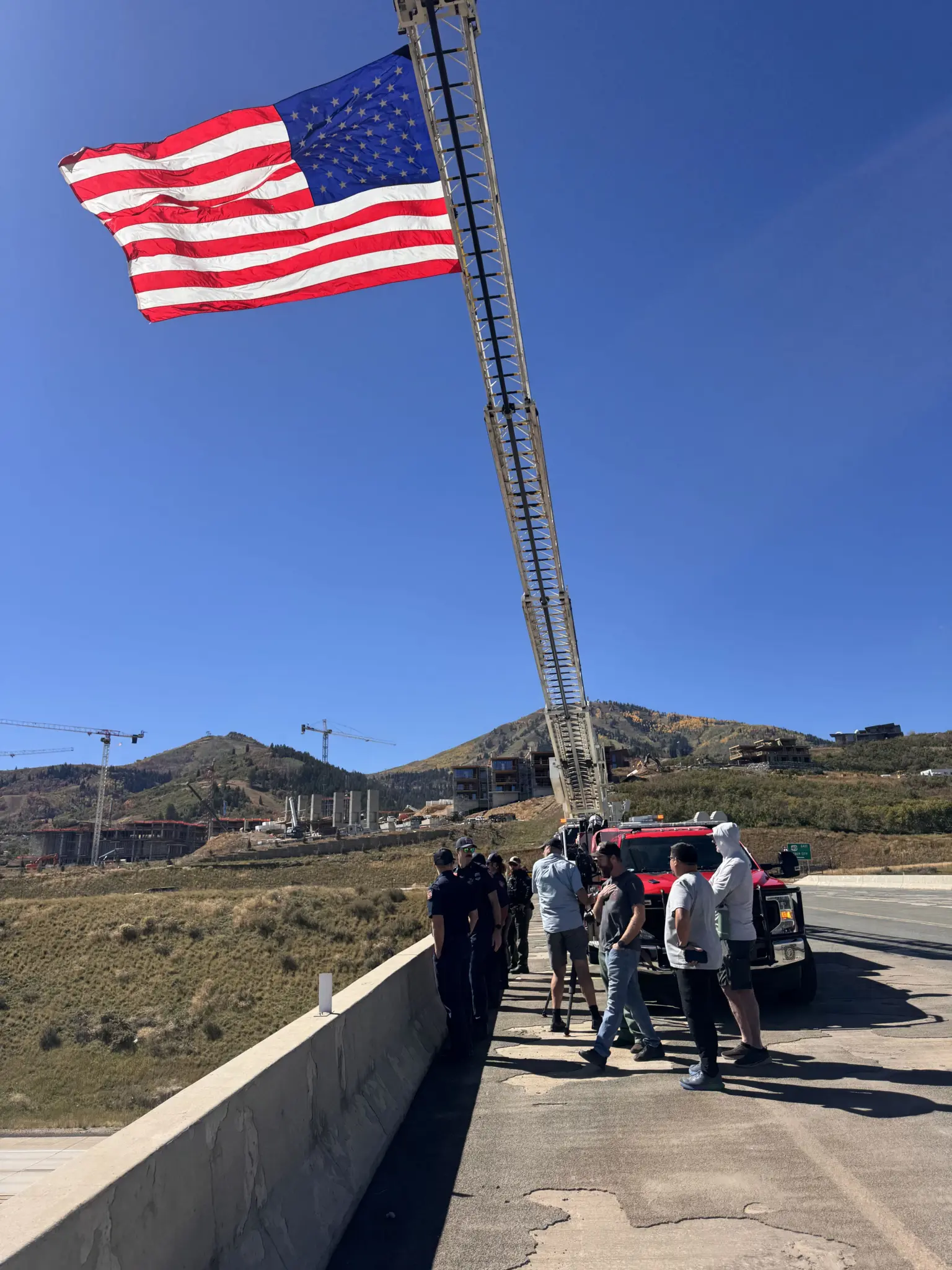 Firefighters and neighbors wait on the Mayflower overpass above U.S. 40 as Ryan Cutter's procession comes through.