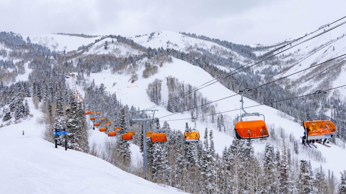 Park City Mountain’s Orange Bubble Express carries skiers above Canyons Village during winter operations.
