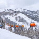 Park City Mountain’s Orange Bubble Express carries skiers above Canyons Village during winter operations.