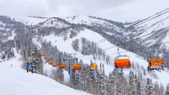 Park City Mountain’s Orange Bubble Express carries skiers above Canyons Village during winter operations.