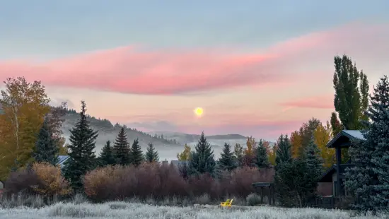 The Hunter’s Moon sets over a fog-draped Snyderville Basin Monday morning, Oct. 26, as frost coats the grass and pink dawn light spreads across the sky. The full moon peaked Sunday night at 10:12 p.m. MDT.